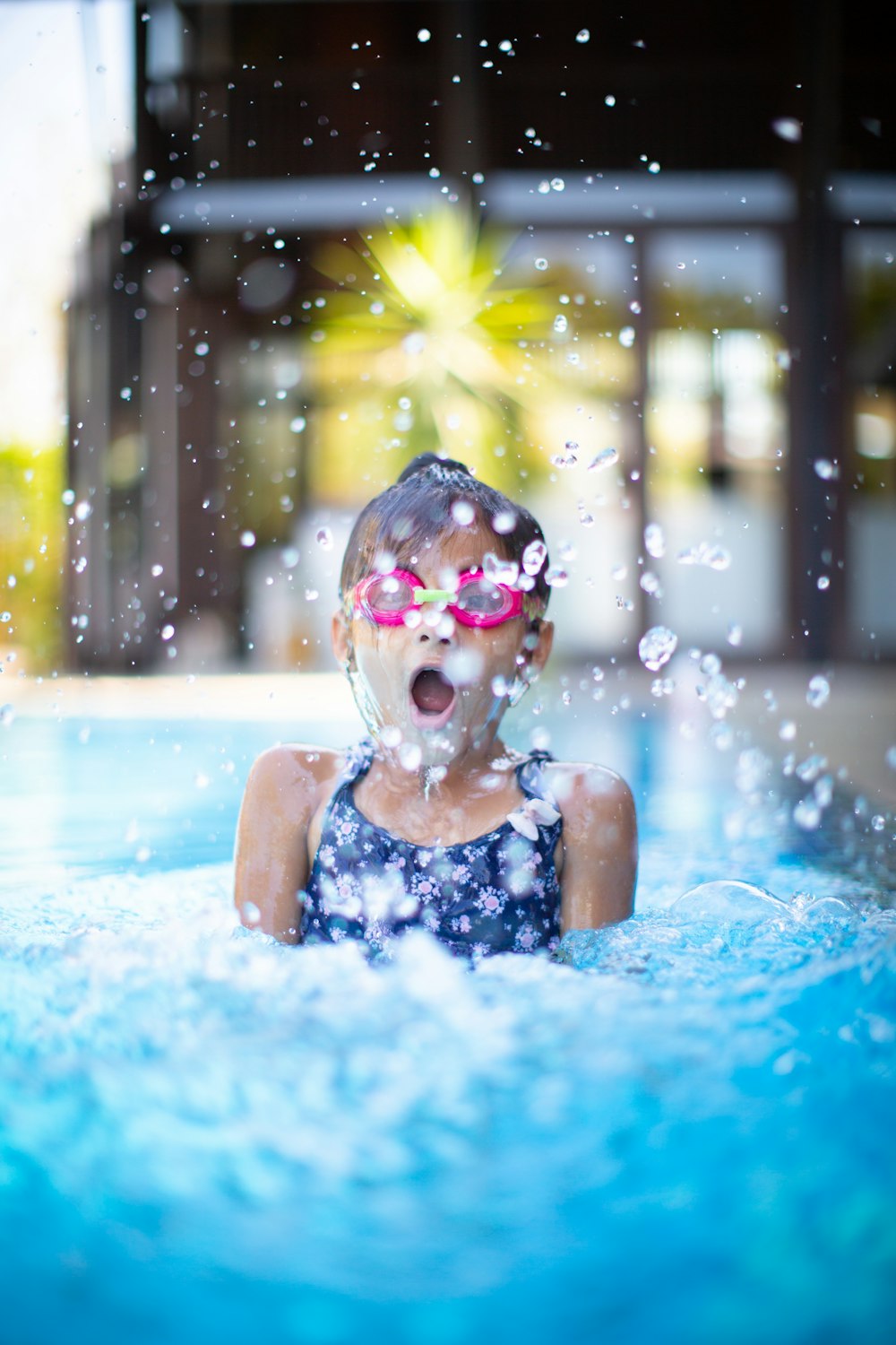 girl swims on swimming pool