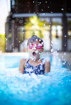 girl swims on swimming pool