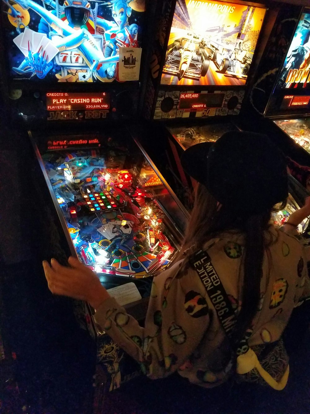 a person playing a game of pinball