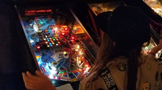 a person playing a game of pinball