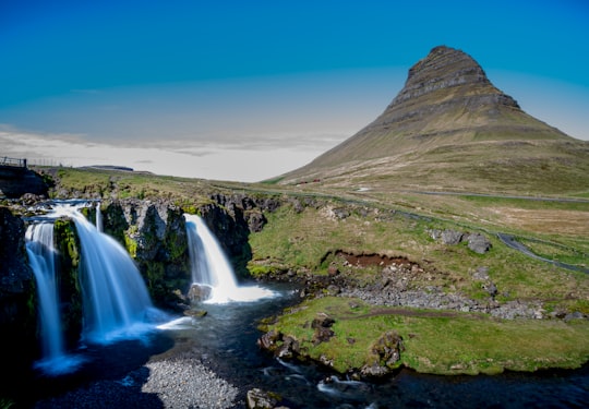 waterfalls under blue sky in Snæfellsjökull National Park Iceland