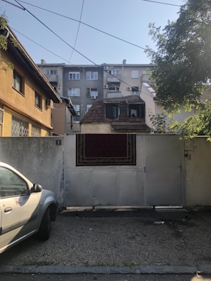 Wide shot of a residential building with an automated electric gate.