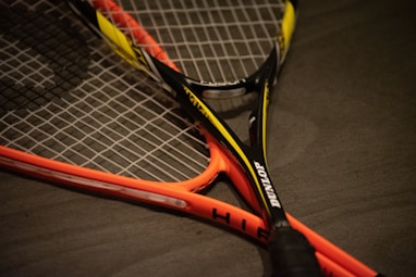 yellow and black Dunlop tennis racket