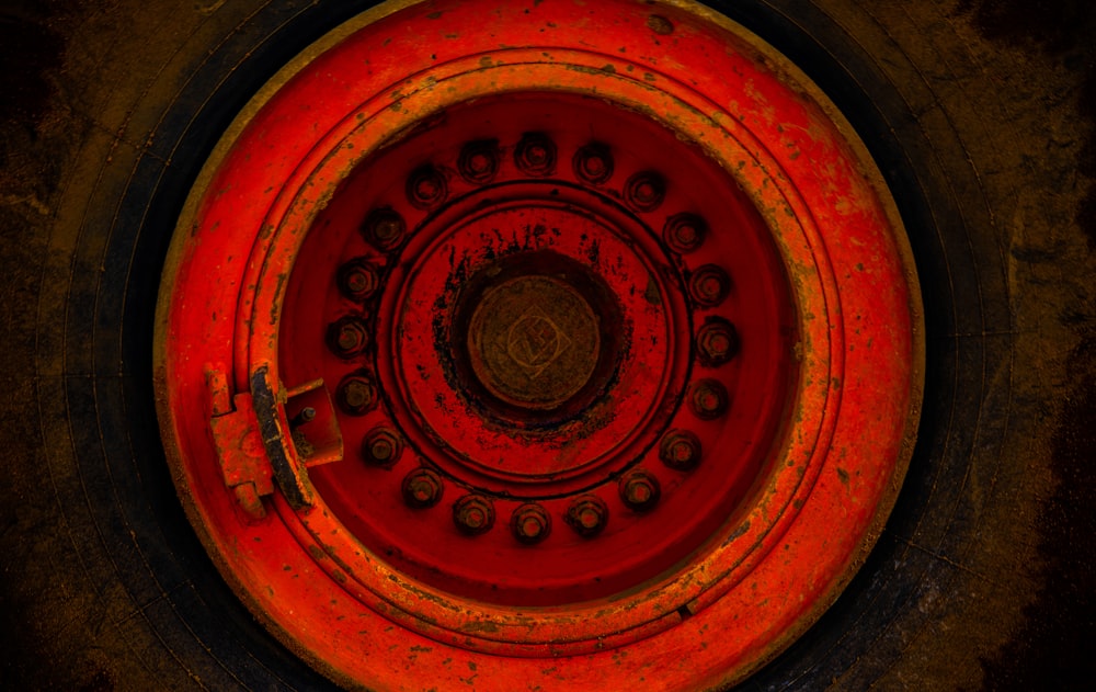 macro photography of round red metal component