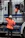 A smiling man shaking hands with a removalist next to an orange and white removal truck.