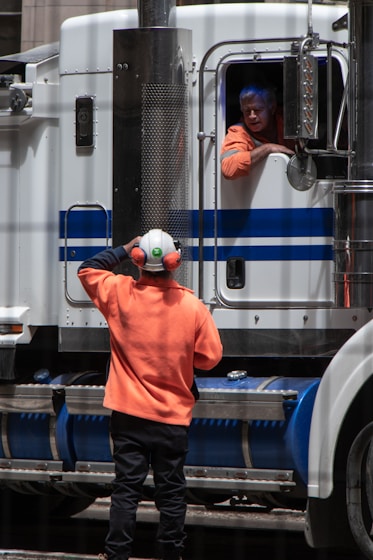 man standing in front of freight truck