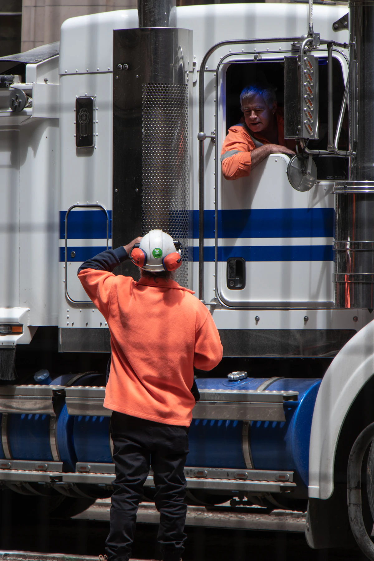 Owner-operator standing in front of his freight truck