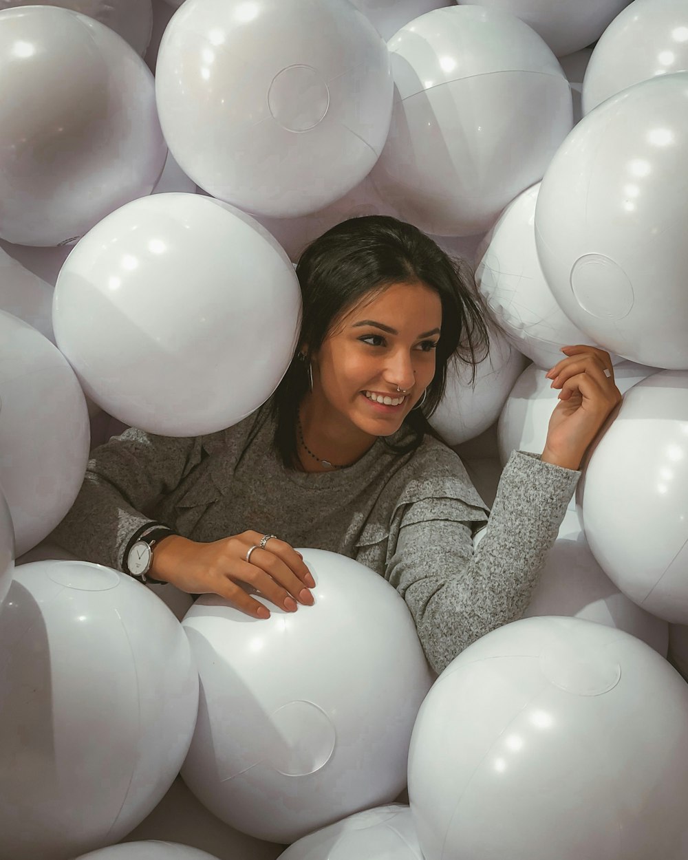 woman wearing grey sweater near the balloon