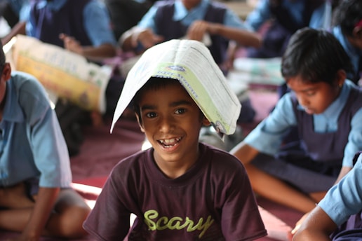 Child with book on his head