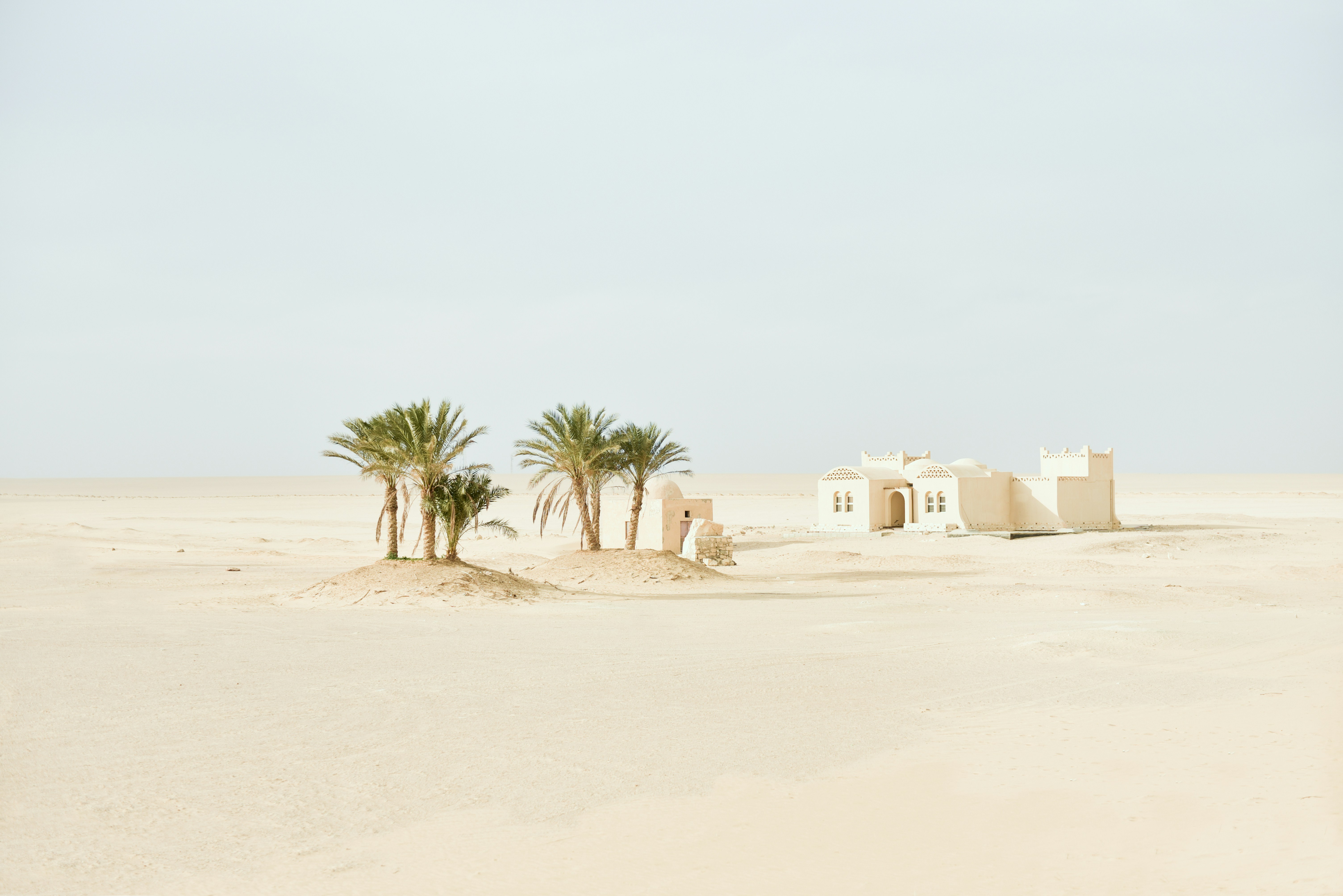 white concrete house on the dessert