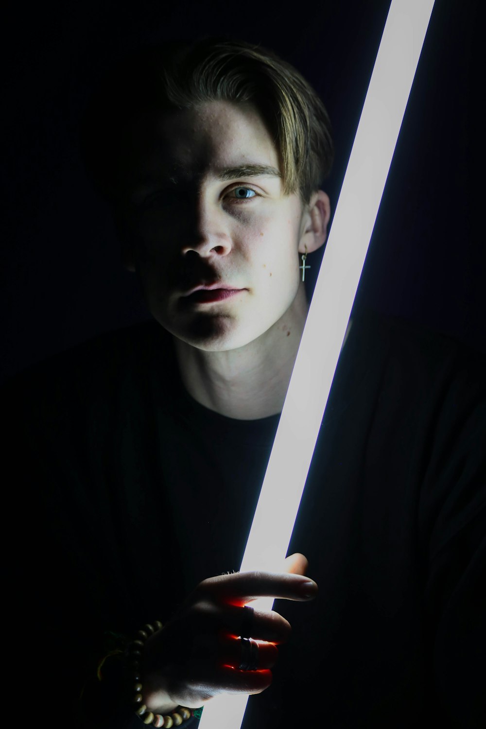 man holding fluorescent lamp