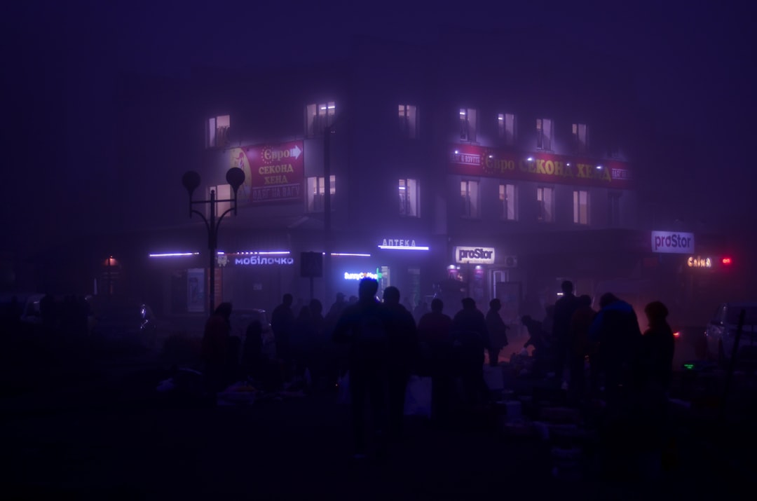 people standing in front of building with lights