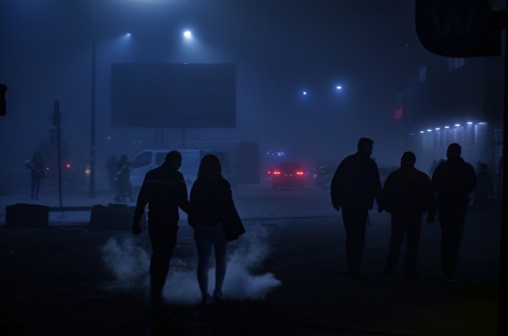 people walking on road near billboard