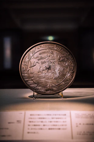 Close-up of a finely engraved wooden plaque with Norse-inspired designs, glowing softly under warm light.