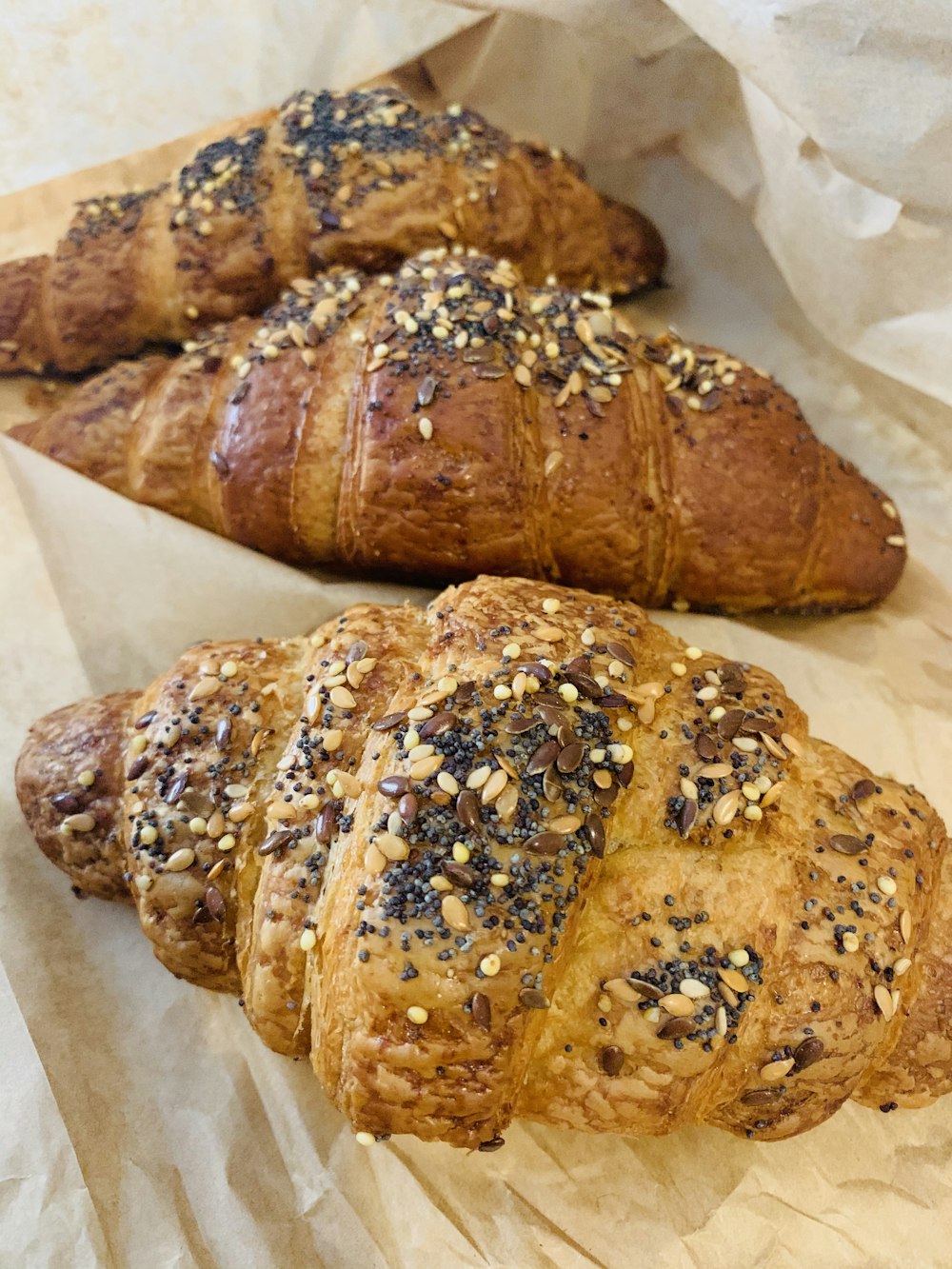 three croissant bread with sesame seeds