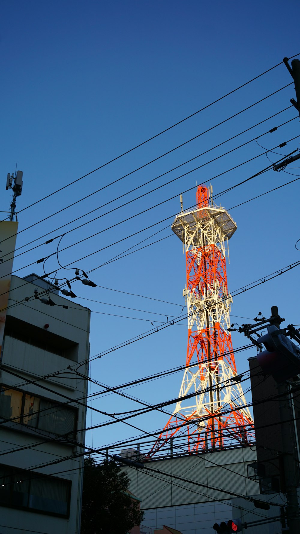 red and white tower beside white concrete building during daytime