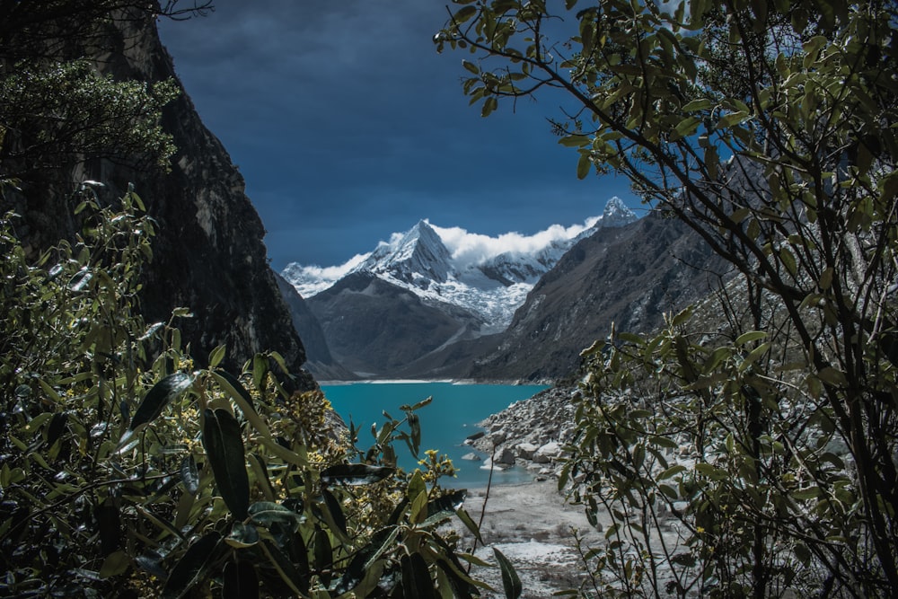 mountain beside body of water during daytime