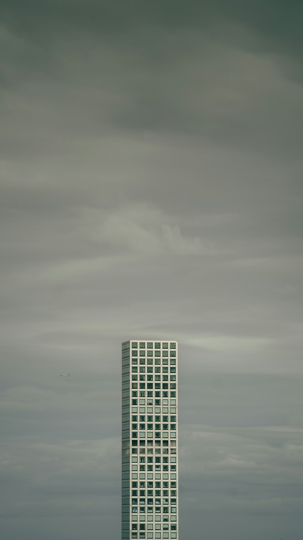 gray high-rise building under cloudy sky during daytime