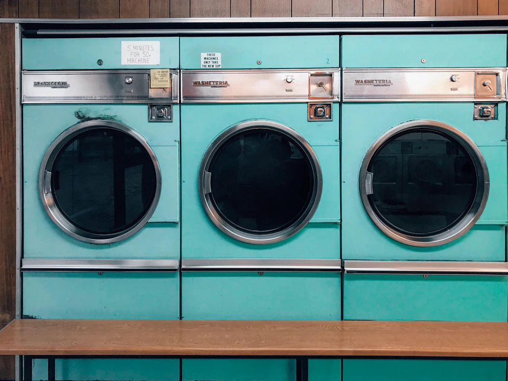Stacked washers and dryers lined up, showcasing the variety available for rent.