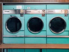 three green front-load washers