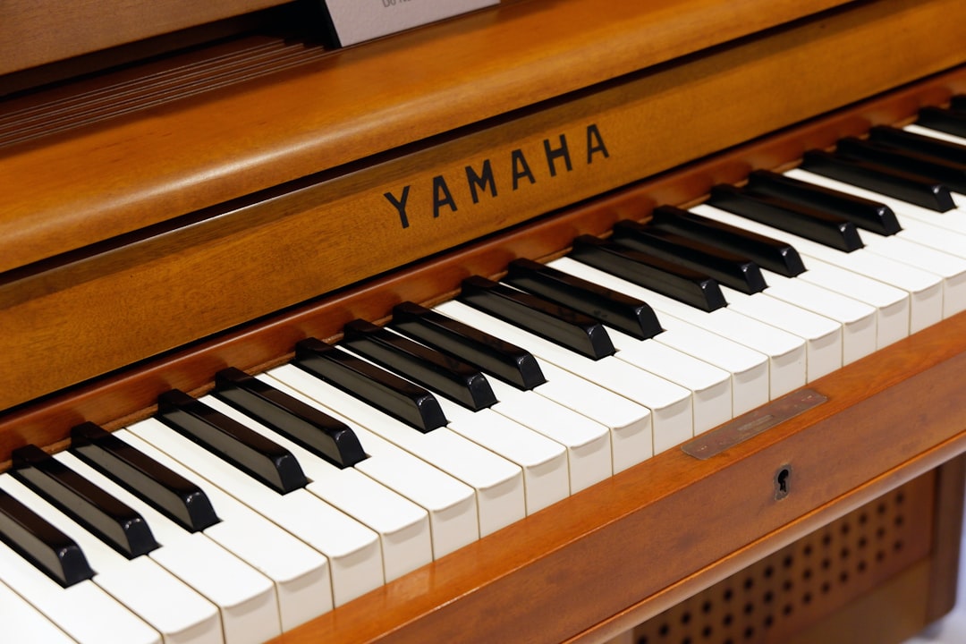 brown and white Yamaha piano