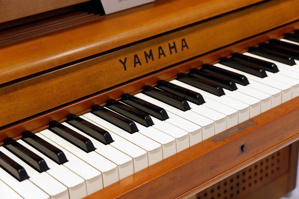 brown and white Yamaha piano