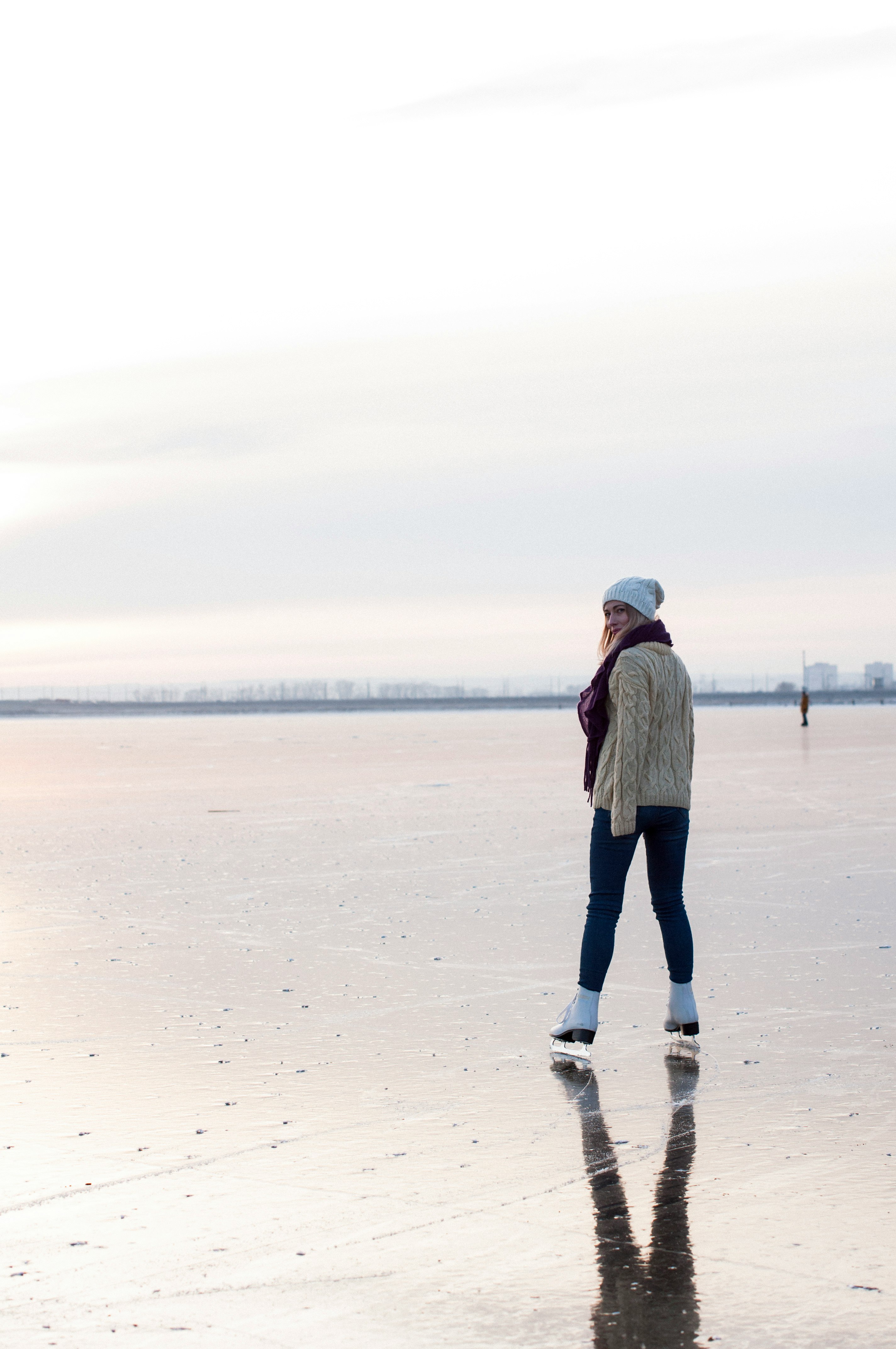 woman ice skating during daytime