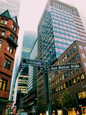 road sign in front of high-rise buildings