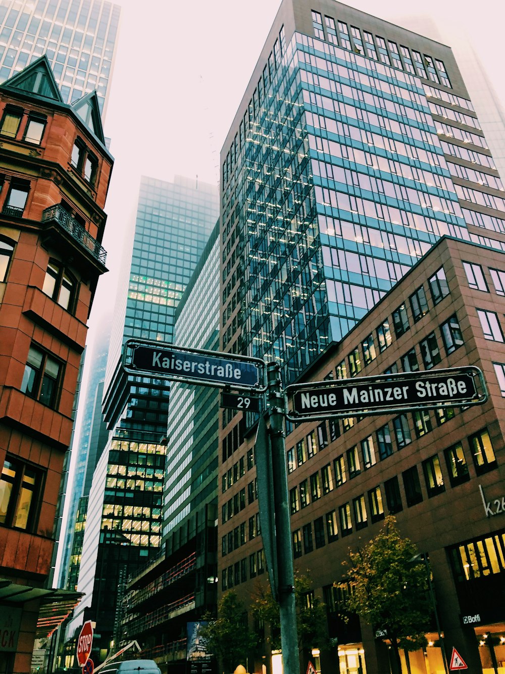 road sign in front of high-rise buildings