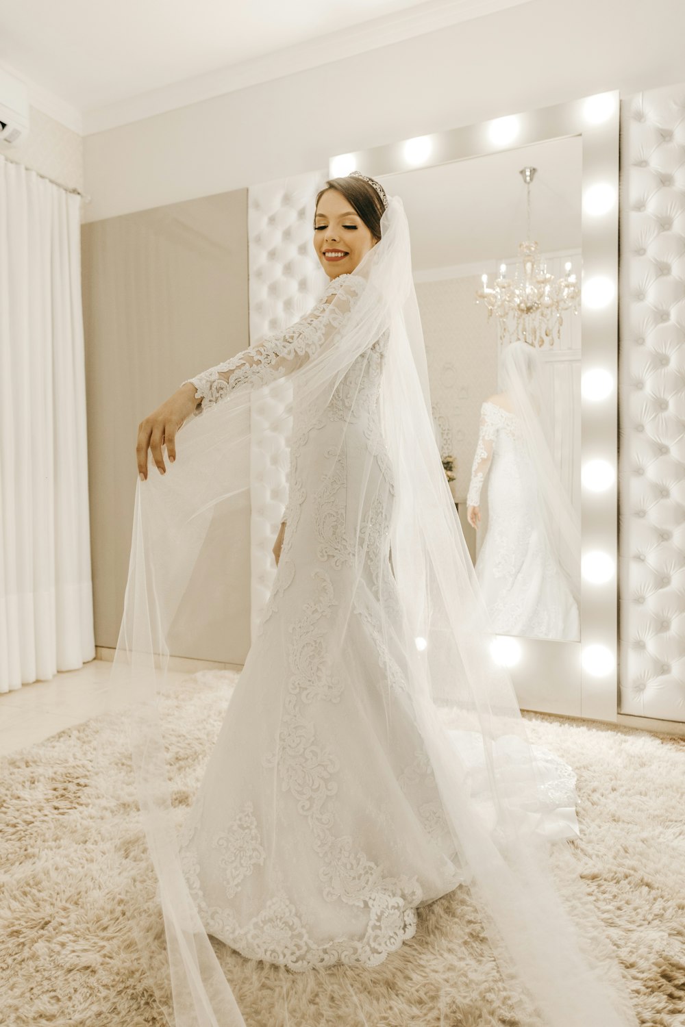 woman wearing white wedding dress in front of mirror