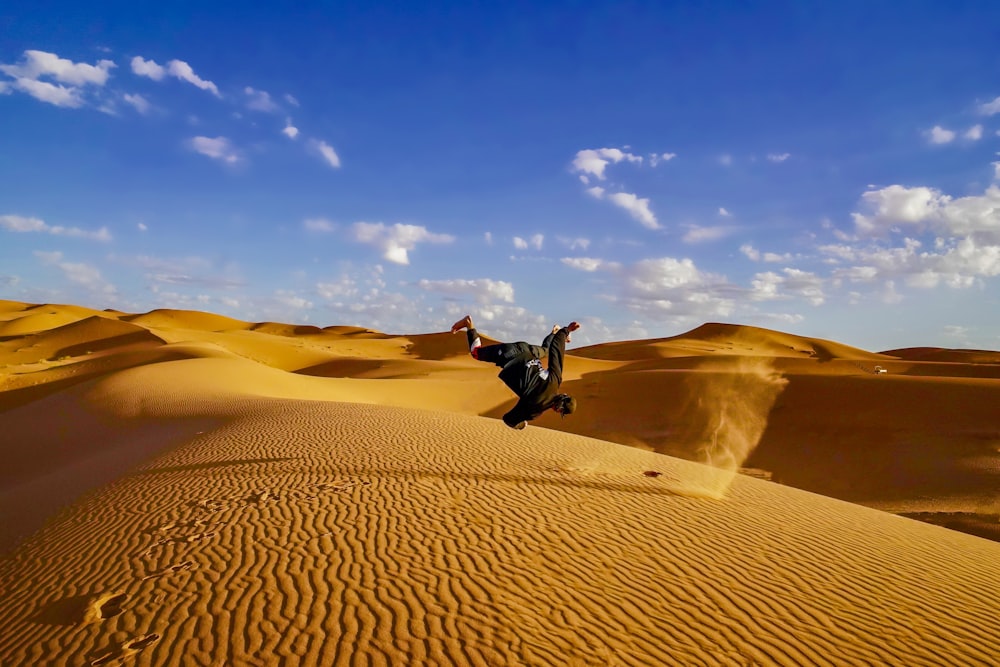 man doing stunt on the dessert