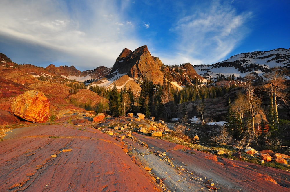 snow-covered mountains under white clouds and blue sky