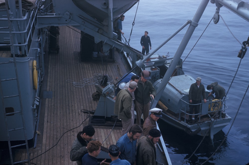 people on ship and boat during day