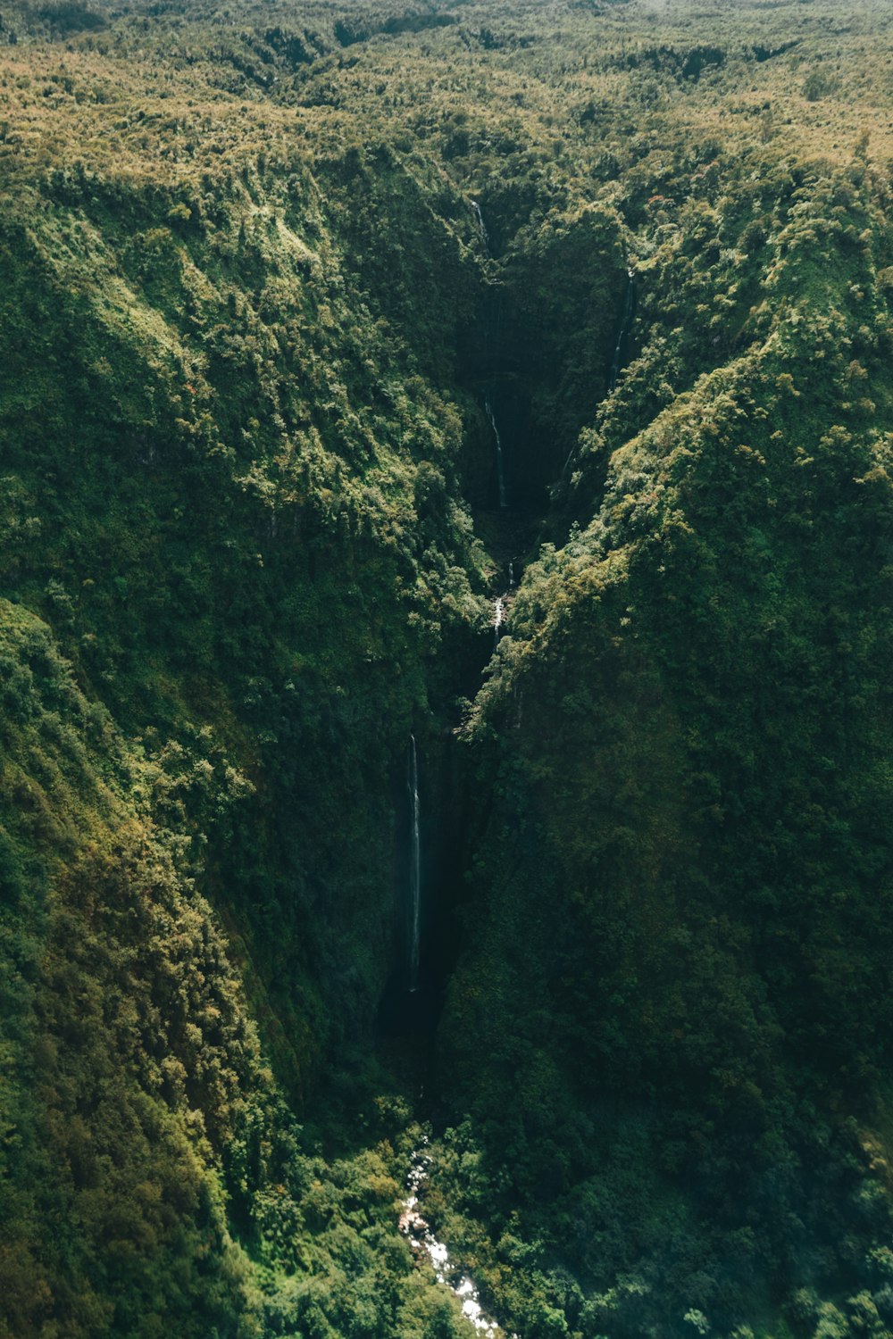 waterfall in mountain during daytime