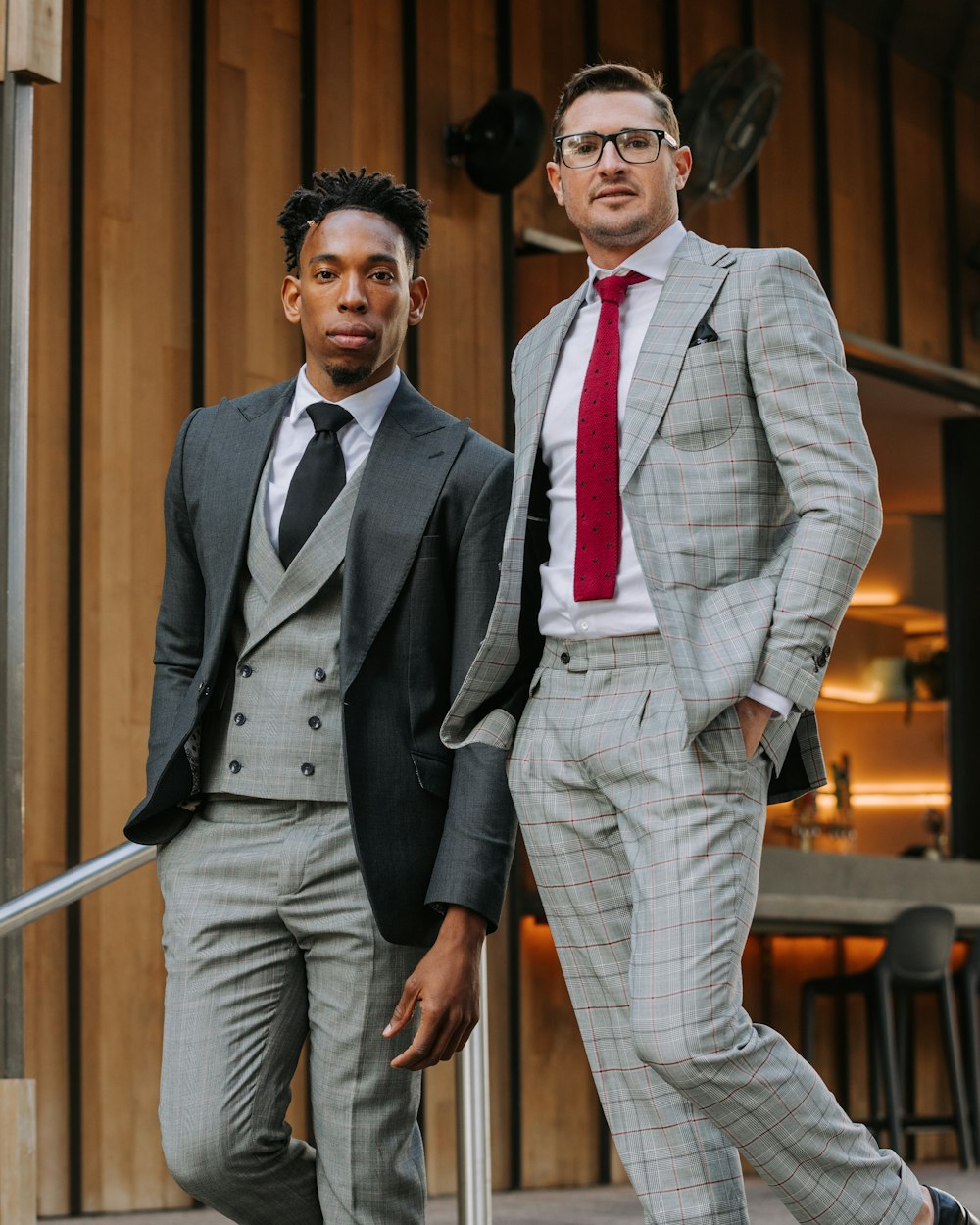 two men standing on stairs