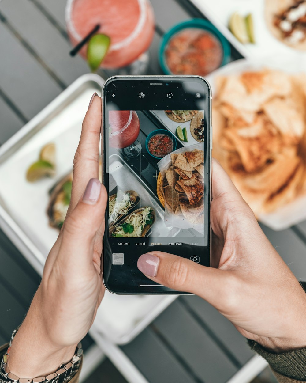 a person taking a picture of food on their phone
