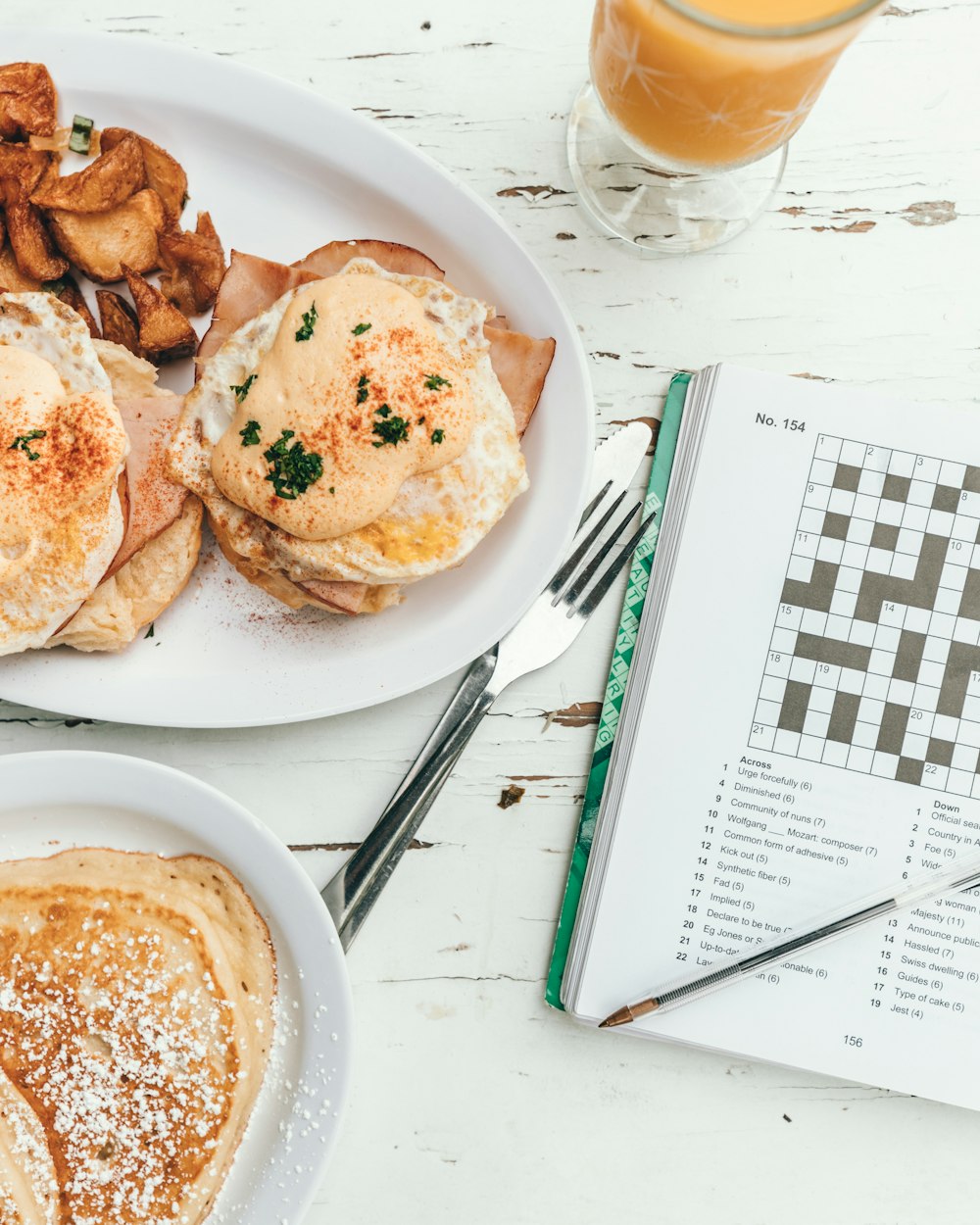 pancake on plate beside opened book