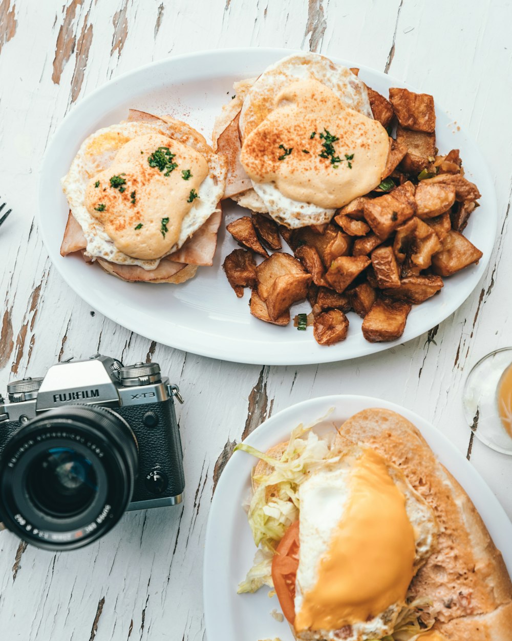 two plates of food on a table with a camera