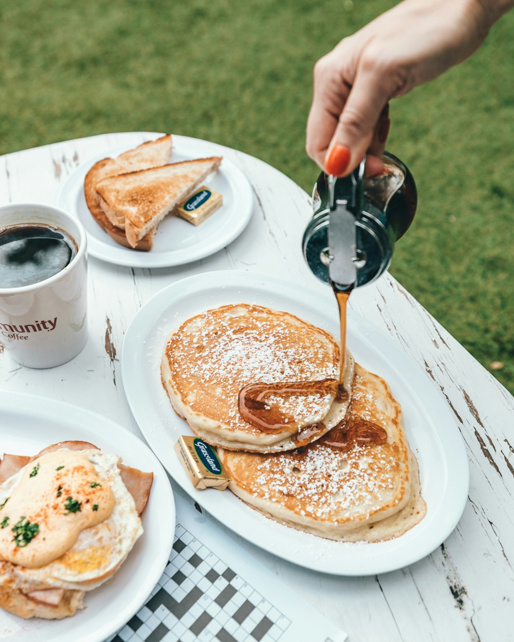 person pouring cream on pancake