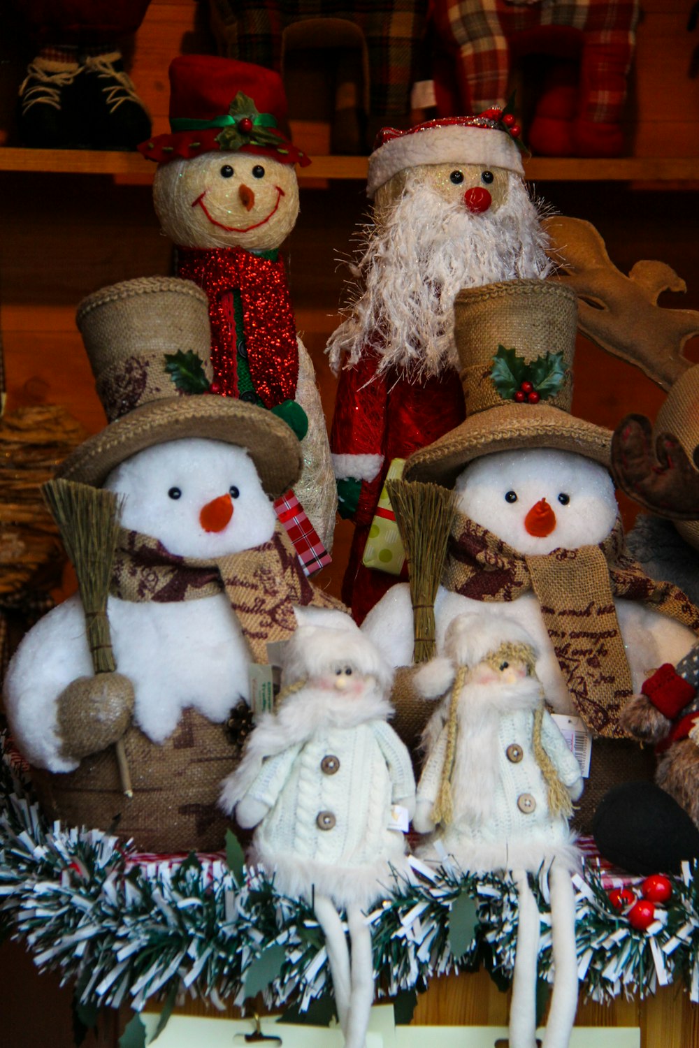 several Santa Claus and snowman plush toys