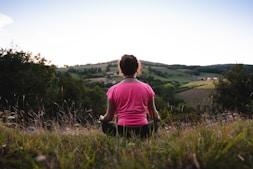 woman squatting in grass
