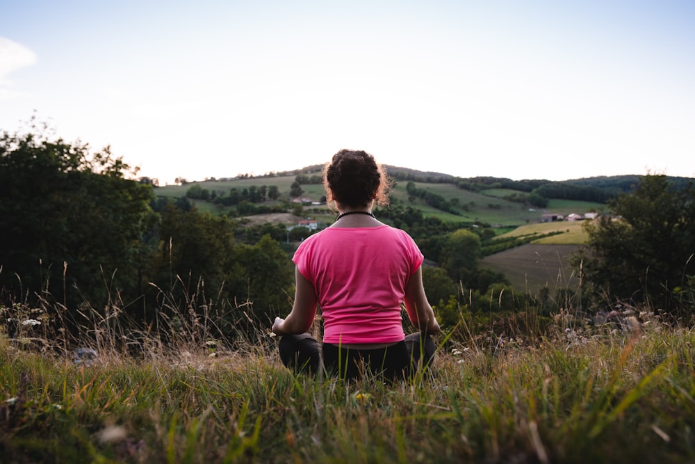 woman squatting in grass