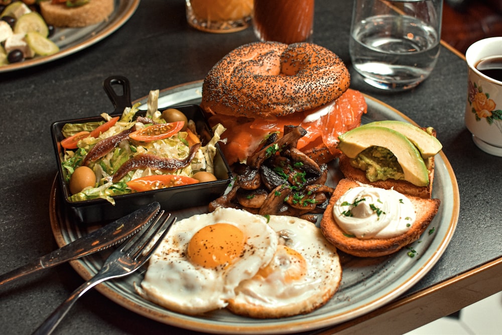 a plate of food on a table with a cup of coffee