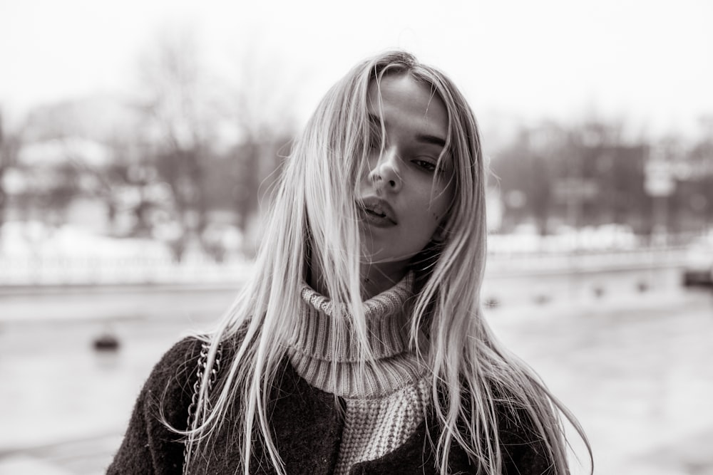 grayscale photography of coat and turtle neck sweater
