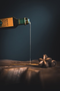 bottle with white liquid pouring through the brown slab
