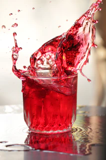 Vibrant splash of Long Jump drink pouring into a glass with ice.