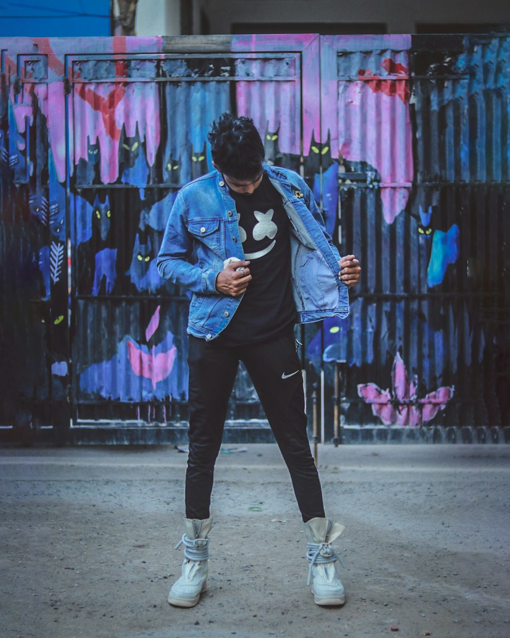 man wearing black shirt and blue denim jacket