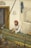 man sitting beside wall painting