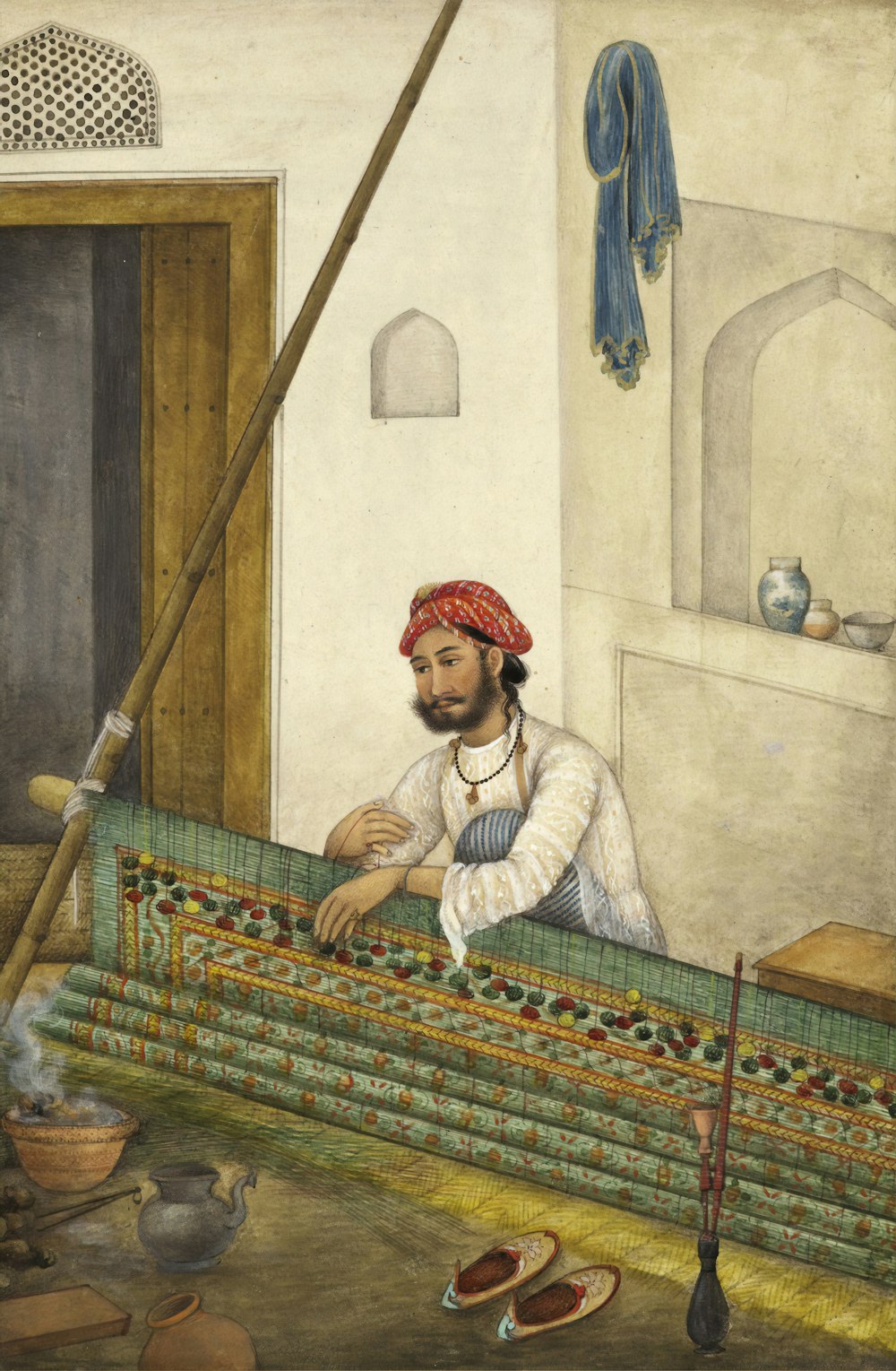hombre sentado al lado de la pintura mural
