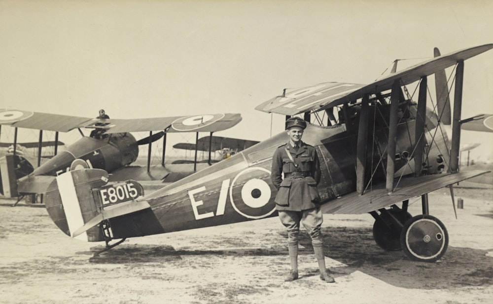 vintage photo of man beside of airplane